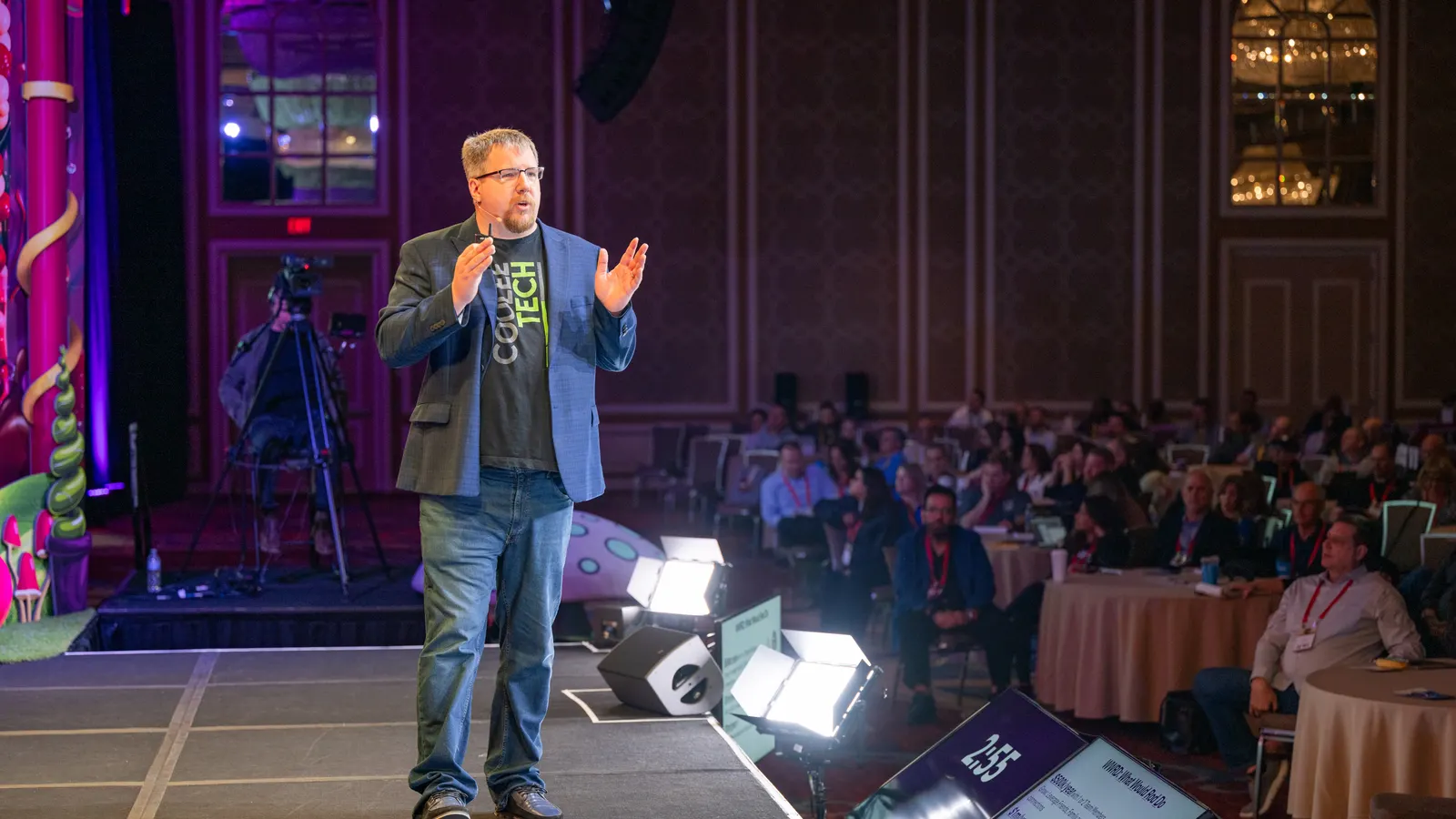Rod Holum speaking on stage to a full room at an AI business conference